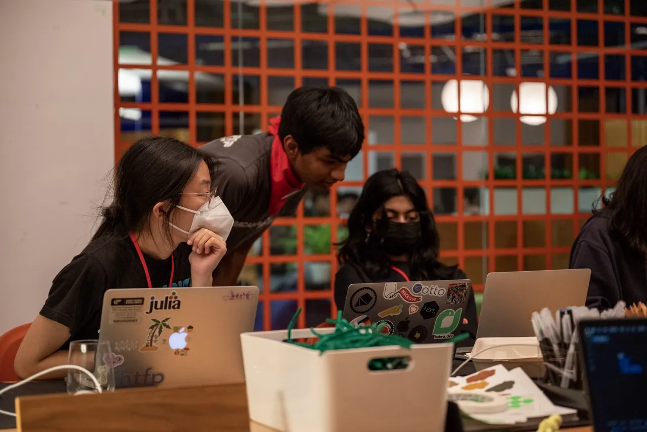 A teenager building a hardware project at a Hack Club hackathon.
